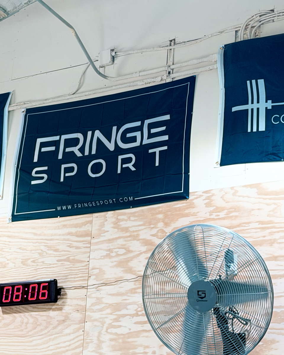 Banners and a Texas flag hung along the gym wall above the workout clock.